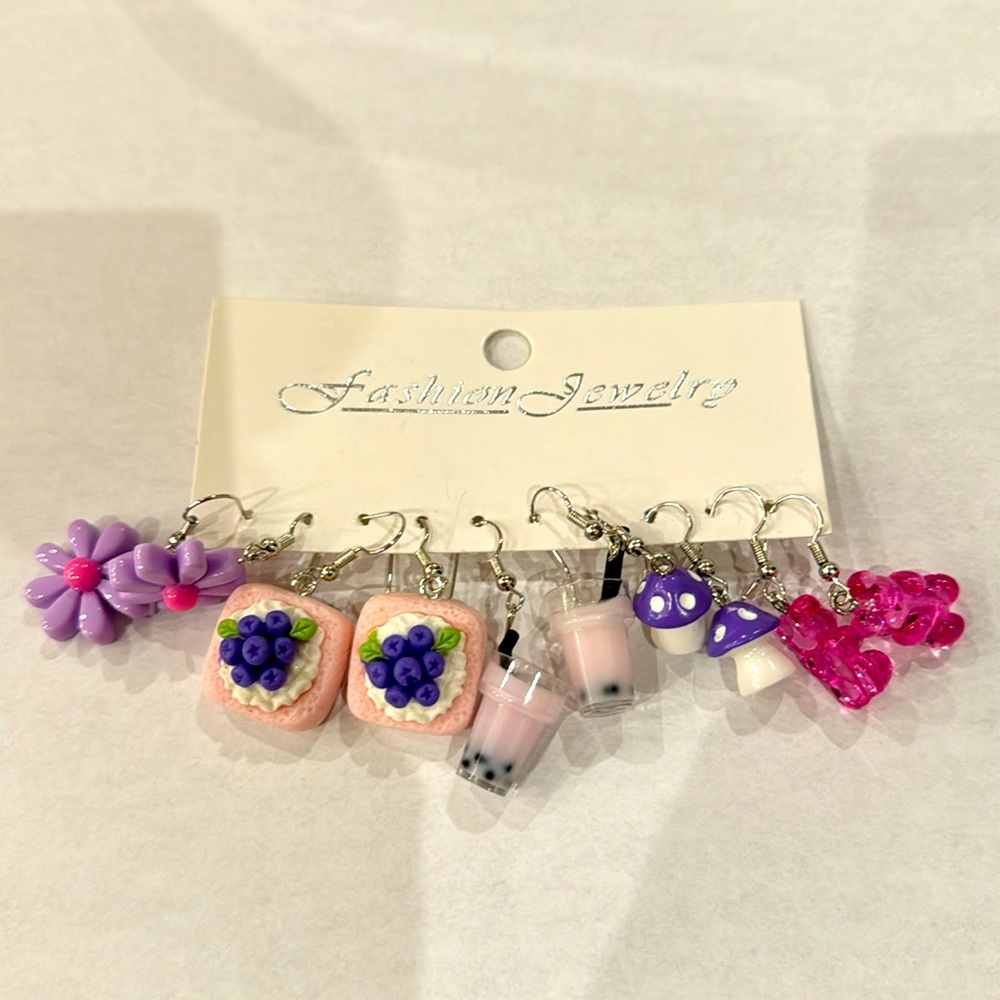 Never worn five piece purple earring set